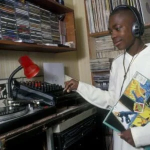 14 year old boy listening to music in his bedroom